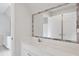 Bathroom vanity features gray-tiled mirror, white cabinets, and a modern faucet at 2305 Lochinver Sw Ln, Conyers, GA 30094
