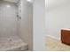 Shower room featuring tiled walls, a rainfall shower head, and tile flooring at 2305 Lochinver Sw Ln, Conyers, GA 30094