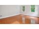 Open bedroom with hardwood floors and sunlit windows at 2305 Lochinver Sw Ln, Conyers, GA 30094