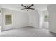 Neutral bedroom has carpet, a ceiling fan and great natural light from two windows at 2305 Lochinver Sw Ln, Conyers, GA 30094