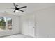 Bright bedroom features a ceiling fan, neutral paint, carpet, and a window allowing natural light at 2305 Lochinver Sw Ln, Conyers, GA 30094