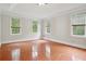 Spacious, open bedroom has hardwood floors and sunlit windows at 2305 Lochinver Sw Ln, Conyers, GA 30094