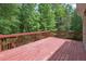 Outdoor deck with wooden railings offering a relaxing space surrounded by trees at 2305 Lochinver Sw Ln, Conyers, GA 30094