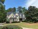 Charming two-story home with well-maintained landscaping, stone accents, and a lush green lawn at 2305 Lochinver Sw Ln, Conyers, GA 30094