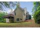 Exterior side view of home showcasing a deck and tree-lined property at 2305 Lochinver Sw Ln, Conyers, GA 30094