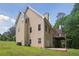 Back exterior view of home shows deck, patio, and well-maintained lawn at 2305 Lochinver Sw Ln, Conyers, GA 30094