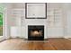 Elegant living room fireplace with marble surround and built-in shelving at 2305 Lochinver Sw Ln, Conyers, GA 30094