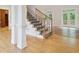 Elegant foyer with hardwood floors, staircase with iron railings, and natural light at 2305 Lochinver Sw Ln, Conyers, GA 30094