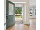 Inviting front door with decorative glass detail, opening to a spacious foyer with hardwood floors at 2305 Lochinver Sw Ln, Conyers, GA 30094