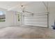 Spacious 2-car garage with bright windows and concrete flooring at 2305 Lochinver Sw Ln, Conyers, GA 30094
