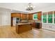 Kitchen with wooden cabinets, granite countertops, island with cooktop, and stainless steel appliances at 2305 Lochinver Sw Ln, Conyers, GA 30094