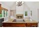 Gourmet kitchen features a center island, stone fireplace, and built-in shelving units at 2305 Lochinver Sw Ln, Conyers, GA 30094