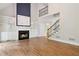 Spacious living room with fireplace, built-in shelving, and hardwood floors at 2305 Lochinver Sw Ln, Conyers, GA 30094