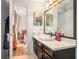 Bathroom with a dark cabinet, granite countertop, a round vessel sink, and a large mirror at 446 Teal Ct, Roswell, GA 30076