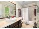 Bathroom featuring a large mirror, vanity with a vessel sink, and a bathtub with a shower curtain at 446 Teal Ct, Roswell, GA 30076
