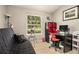 Bedroom with a futon, desk setup, and a large window with a view of the outdoors at 446 Teal Ct, Roswell, GA 30076