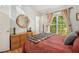 Bright bedroom with natural light, decorative mirror and wood dresser at 446 Teal Ct, Roswell, GA 30076