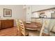 Cozy dining area with wood table, chairs, and hanging wine glass rack in the kitchen at 446 Teal Ct, Roswell, GA 30076