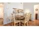 Inviting dining area with a wooden table set for four and convenient pass-through to the kitchen at 446 Teal Ct, Roswell, GA 30076