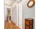Bright hallway with wood floors, closet, and a view leading into a bedroom at 446 Teal Ct, Roswell, GA 30076