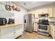 Eat-in kitchen features stainless steel appliances, ample counter space and hanging pot rack at 446 Teal Ct, Roswell, GA 30076