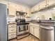Modern kitchen features stainless steel appliances, undermount sink, and shaker cabinets at 446 Teal Ct, Roswell, GA 30076