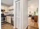 Galley kitchen view into the living room with stainless steel appliances and shaker cabinets at 446 Teal Ct, Roswell, GA 30076