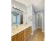 Bathroom featuring double sinks, solid surface countertops, tile floor and a soaking tub at 698 Beranda Cir, Douglasville, GA 30134