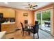Dining area features a glass table, seating for four, wood floors and sliding glass doors leading to a patio at 698 Beranda Cir, Douglasville, GA 30134