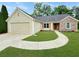 Charming one-story home featuring a stone facade, manicured lawn and convenient two-car garage at 698 Beranda Cir, Douglasville, GA 30134