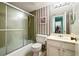 Full bathroom with a shower-tub combination and patterned wallpaper at 7098 Stonington Dr, Atlanta, GA 30328