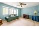 Bright bedroom featuring a large window and ceiling fan for added comfort at 7098 Stonington Dr, Atlanta, GA 30328