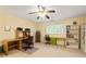 Bedroom featuring two desks, shelving, a ceiling fan, and natural light from the window at 7098 Stonington Dr, Atlanta, GA 30328