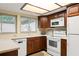Charming kitchen with a view from the window, white appliances, and natural light at 7098 Stonington Dr, Atlanta, GA 30328