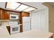 Well-lit kitchen features wooden cabinets, a white refrigerator, a range, and ample countertop space at 7098 Stonington Dr, Atlanta, GA 30328