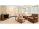 Bright living room featuring comfortable plaid seating, and natural light from the windows at 7098 Stonington Dr, Atlanta, GA 30328