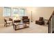 Cozy living room featuring comfortable seating, a glass-top coffee table, and ample natural light from large windows at 7098 Stonington Dr, Atlanta, GA 30328