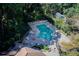 Aerial view of a secluded community pool surrounded by mature trees and lounge chairs at 7098 Stonington Dr, Atlanta, GA 30328