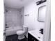 Modern bathroom featuring black and white tile, new fixtures, and a shower over tub at 1111 Osborne Sw St, Atlanta, GA 30310