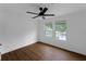 Bright bedroom with wood floors, ceiling fan, and windows overlooking the yard at 1111 Osborne Sw St, Atlanta, GA 30310