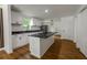 A modern kitchen featuring white cabinetry, stainless steel appliances, and a spacious center island at 1111 Osborne Sw St, Atlanta, GA 30310