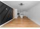 Bright living room features modern open floorplan with luxury wood floors and stylish accent wall at 1111 Osborne Sw St, Atlanta, GA 30310