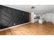 A bright living room features an accent wall, hardwood floors, modern lighting, and opens to a kitchen at 1111 Osborne Sw St, Atlanta, GA 30310