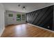 A bright living room with light hardwood floors, an accent wall, and a large entry door with windows at 1111 Osborne Sw St, Atlanta, GA 30310