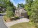 Aerial view of brick home, two-car garage, and surrounding mature trees at 1459 Hickory Branch Nw Trl, Kennesaw, GA 30152