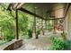 The home features a cozy covered back porch with stone pillars and a wooded view at 1459 Hickory Branch Nw Trl, Kennesaw, GA 30152