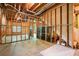 Awaiting finishing, the basement features open ceilings, framed walls, and an access to the outside at 1459 Hickory Branch Nw Trl, Kennesaw, GA 30152