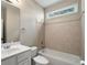 Clean bathroom features a shower-tub combo, neutral tile, and a transom window at 1459 Hickory Branch Nw Trl, Kennesaw, GA 30152