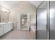 Bathroom featuring a walk-in shower, soaking tub, double sinks, and access to the main bedroom at 1459 Hickory Branch Nw Trl, Kennesaw, GA 30152