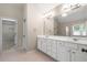 Bathroom with double sink vanity and walk-in closet access at 1459 Hickory Branch Nw Trl, Kennesaw, GA 30152